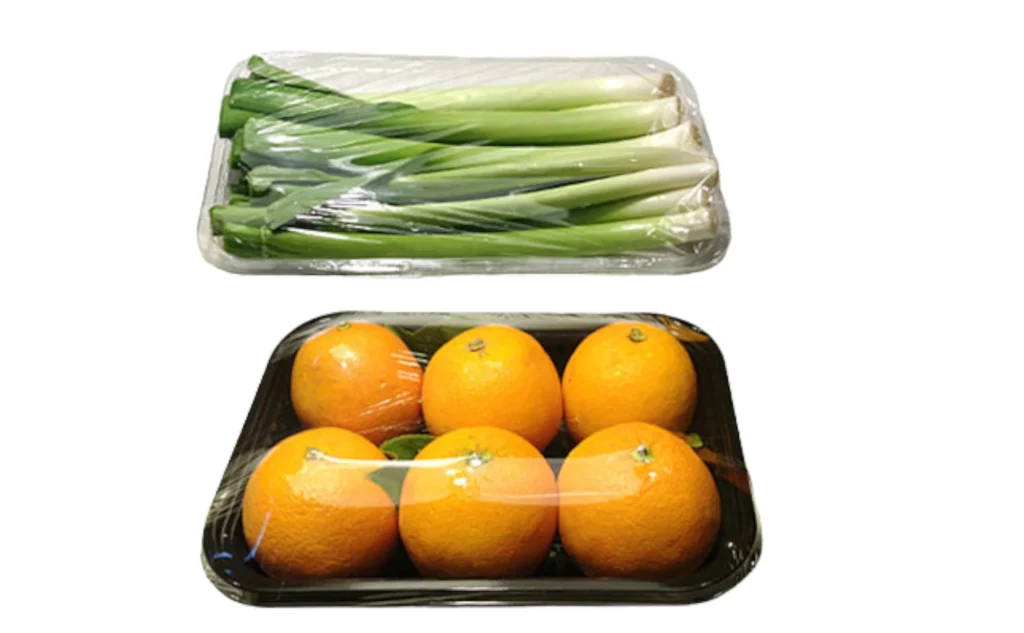 Fresh produce on trays wrapped in cling film