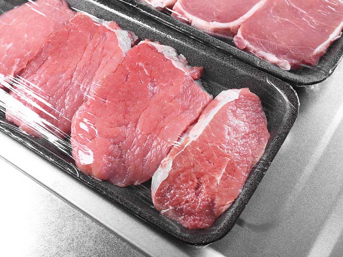 Meat trays wrapped in cling film