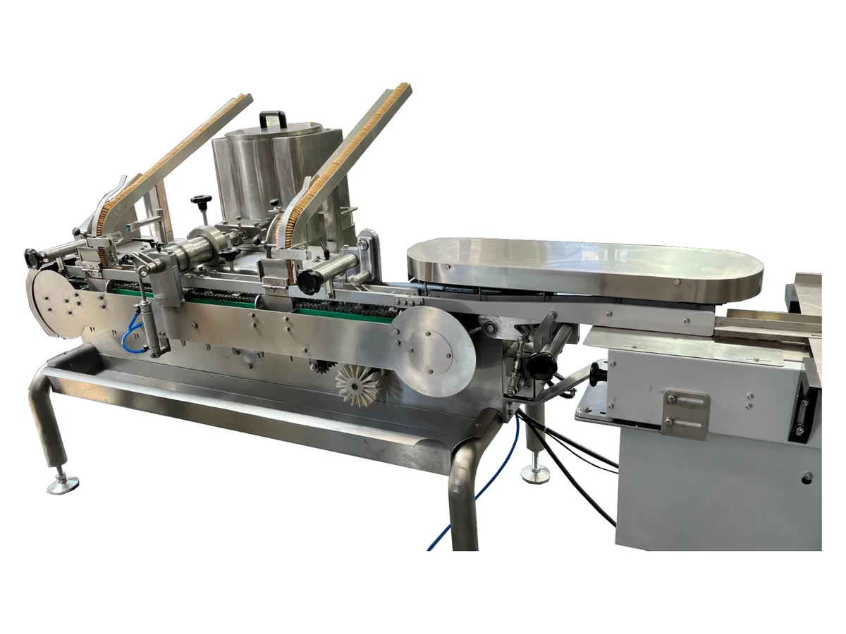 Cream biscuit sandwich machine feeding a flow wrap machine