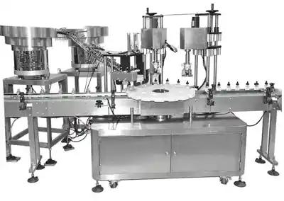 Glass bottle filler and capper with inner and outer cap sorters and a rotary table
